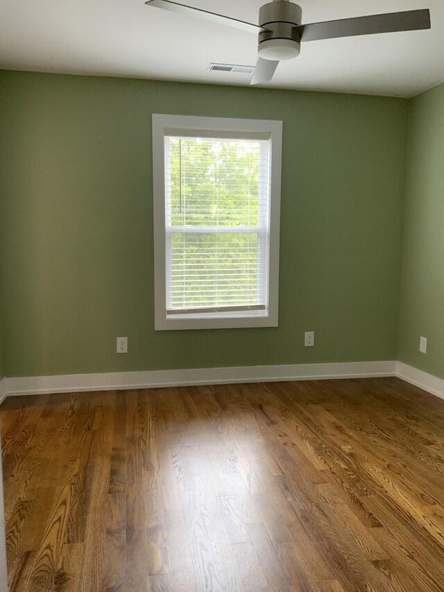 unfurnished room with hardwood / wood-style flooring and ceiling fan