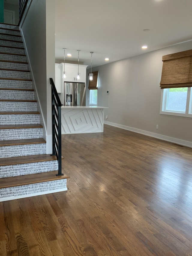 staircase with hardwood / wood-style flooring