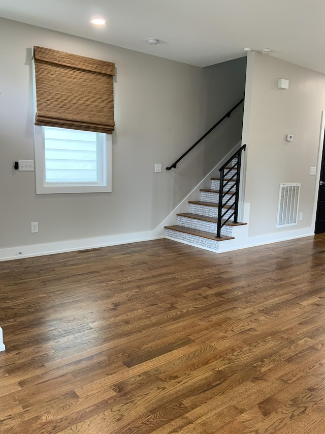 staircase with hardwood / wood-style flooring