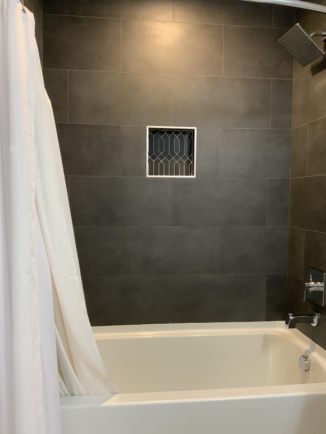 bathroom with shower / tub combo with curtain