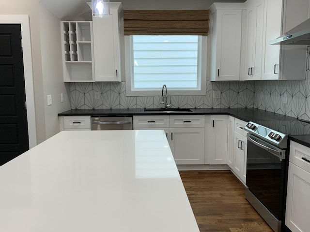 kitchen with white cabinetry, sink, stainless steel appliances, and wall chimney exhaust hood