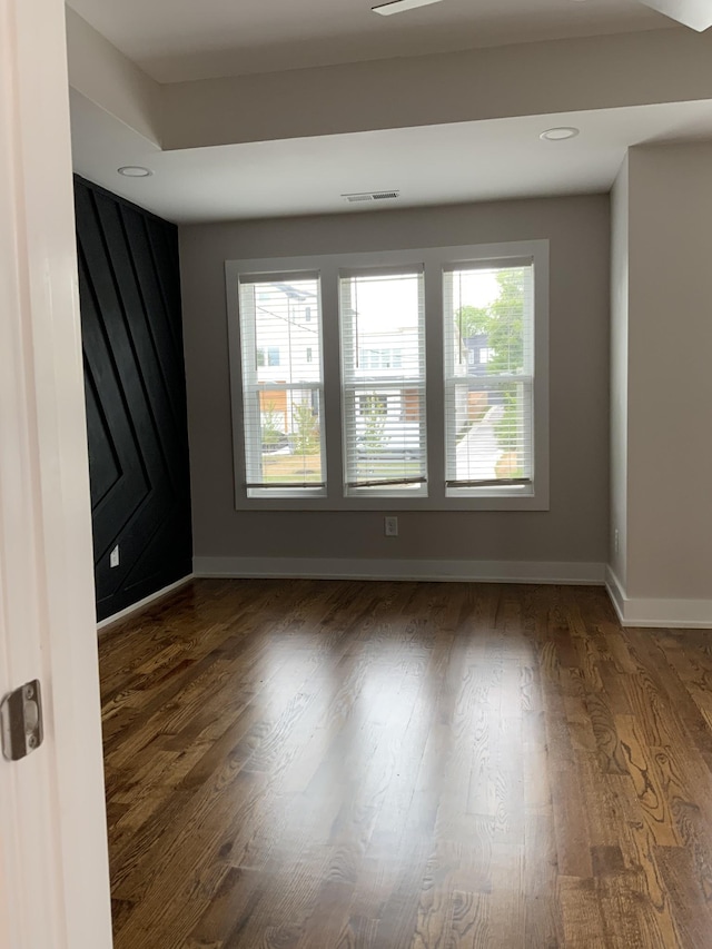 spare room with dark hardwood / wood-style floors