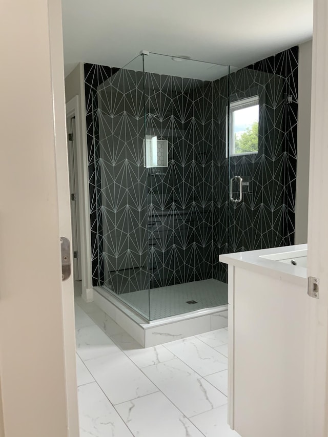 bathroom featuring vanity and a shower with shower door