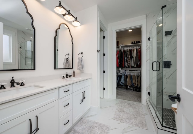 bathroom with vanity and a shower with door