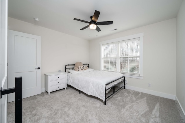 bedroom featuring light carpet and ceiling fan