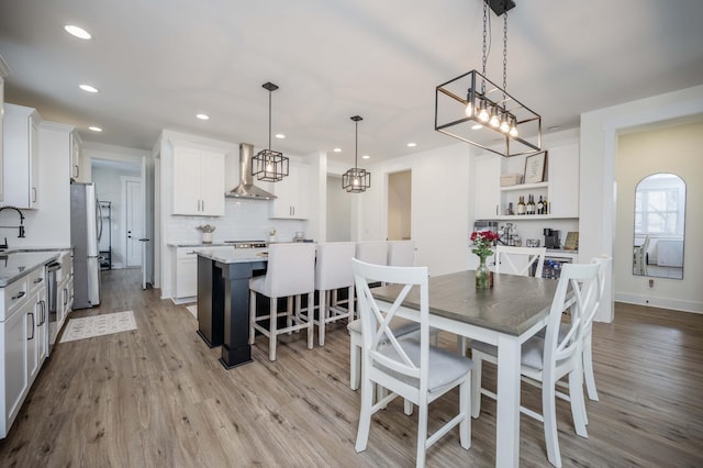 dining space featuring sink and light hardwood / wood-style flooring