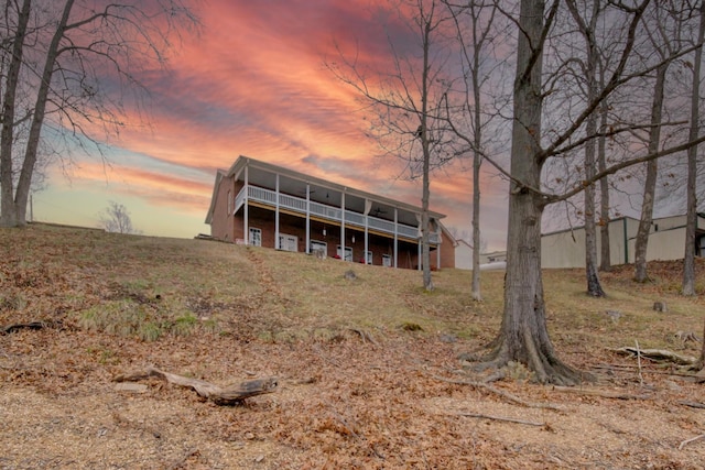 back house at dusk featuring a deck