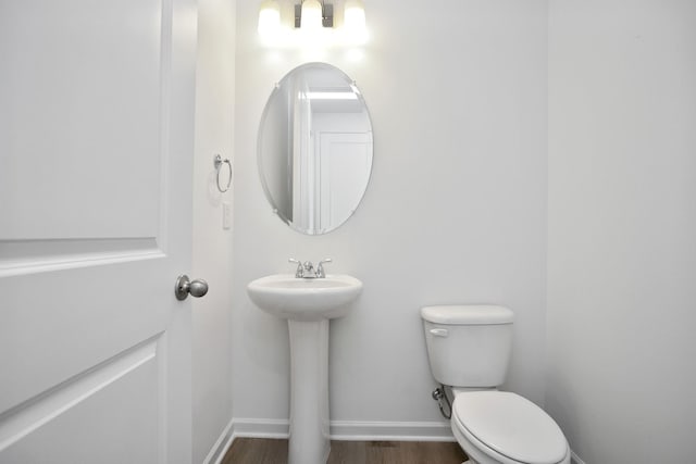 bathroom featuring sink, toilet, and hardwood / wood-style floors