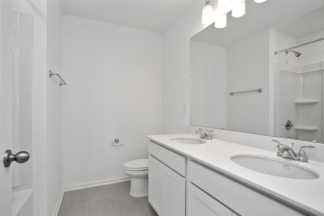 bathroom featuring tile patterned flooring, vanity, a shower, and toilet