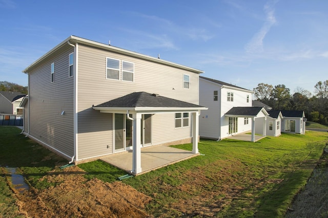 rear view of house with a yard and a patio