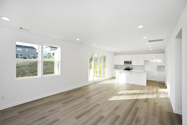 unfurnished living room with light hardwood / wood-style flooring