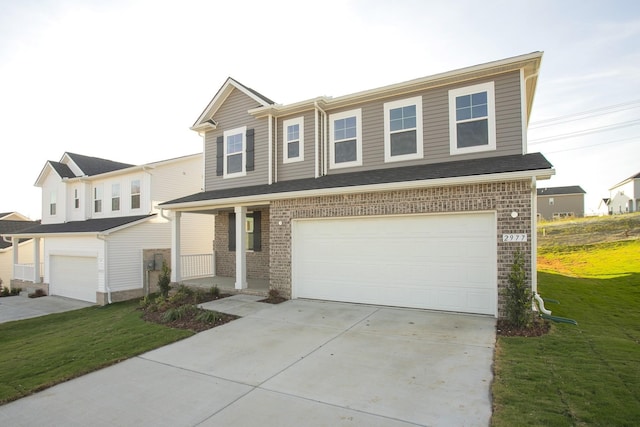 view of front of house featuring a garage and a front lawn