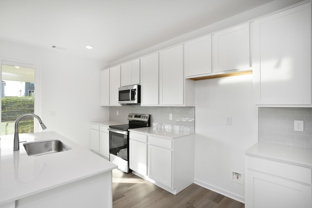 kitchen featuring stainless steel appliances, sink, and white cabinets