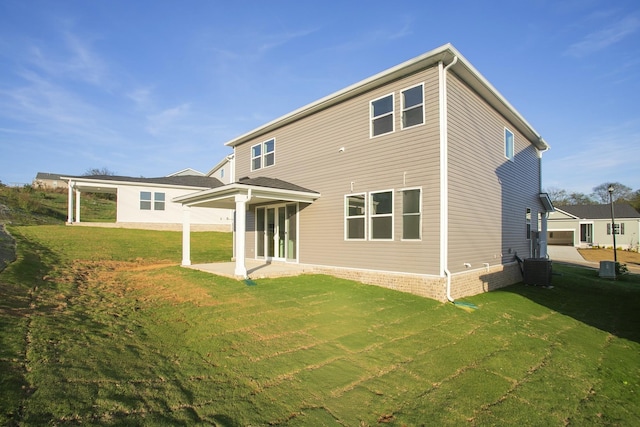 back of property featuring central AC, a yard, and a patio