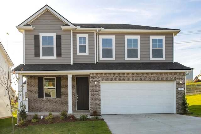 view of front of property featuring a garage and a front lawn