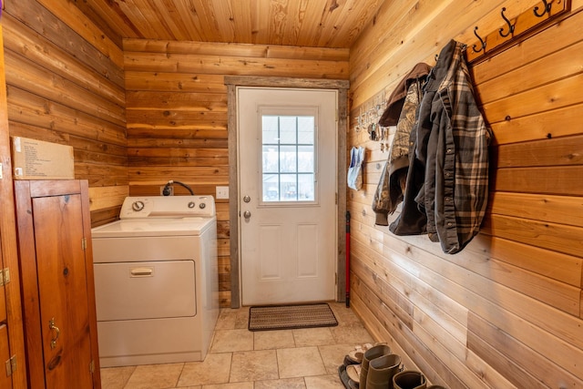 clothes washing area featuring washer / dryer, wood ceiling, and wood walls