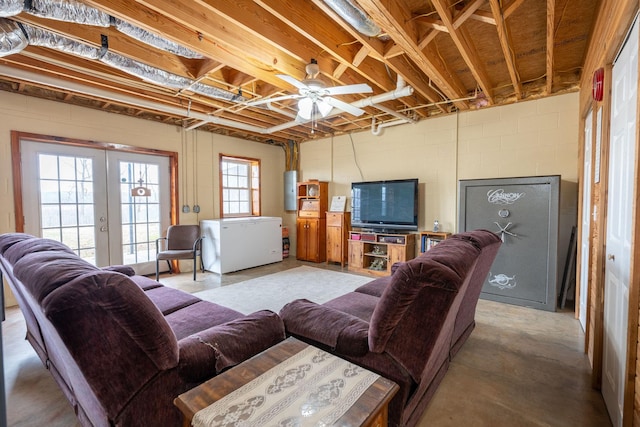 living room featuring french doors and concrete floors