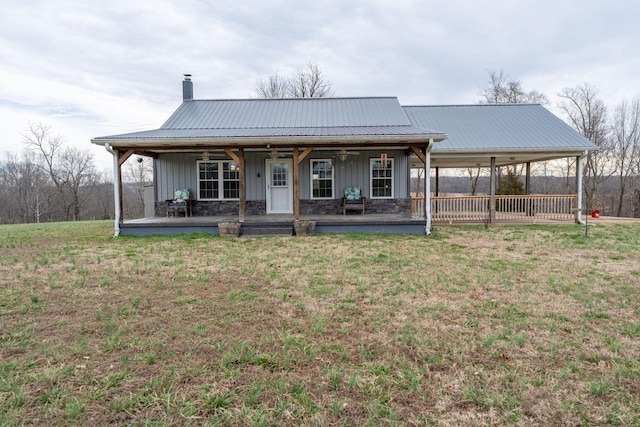 rear view of house with a yard and a porch