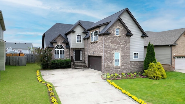 view of front of house featuring a garage and a front lawn