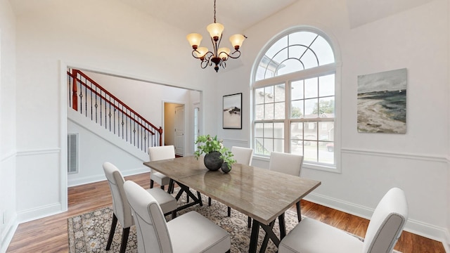 dining space featuring an inviting chandelier and hardwood / wood-style floors