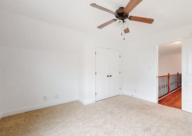 spare room with carpet floors and ceiling fan