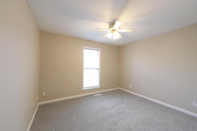 spare room with ceiling fan and carpet floors