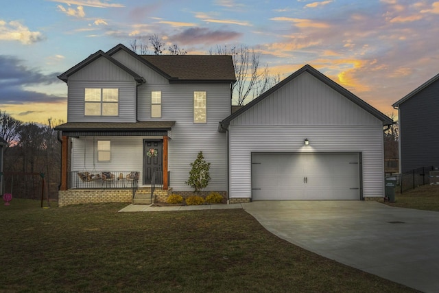 view of front facade featuring a garage, a yard, and covered porch