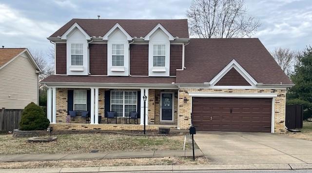 view of front of house featuring covered porch and a garage