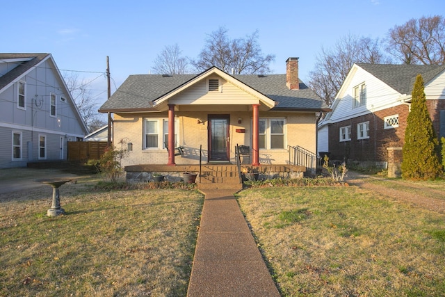 bungalow featuring a front yard and a porch