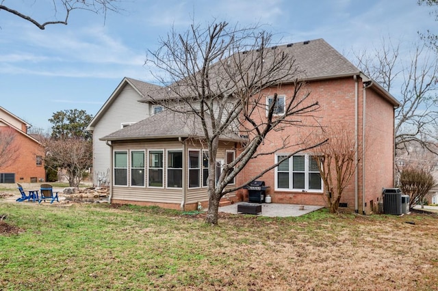 rear view of house featuring central AC unit, a patio, and a lawn