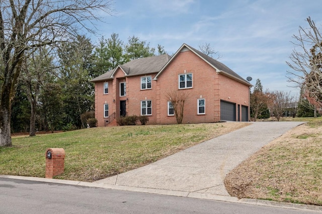 colonial inspired home featuring a garage, a front yard, and driveway