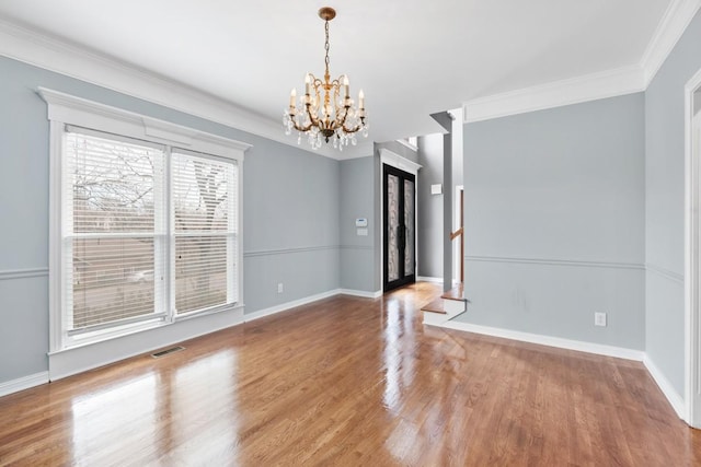 interior space with hardwood / wood-style flooring, crown molding, and a chandelier