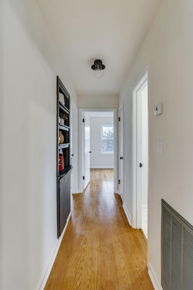 hallway with light wood-type flooring