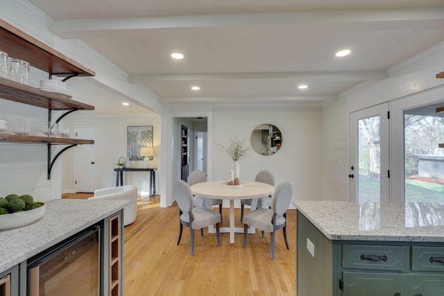 dining room with beamed ceiling, beverage cooler, and light hardwood / wood-style flooring