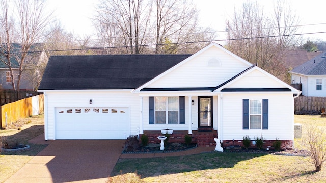 view of front of property with a garage, a front yard, concrete driveway, and fence