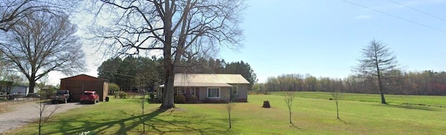 view of yard featuring a rural view and a shed