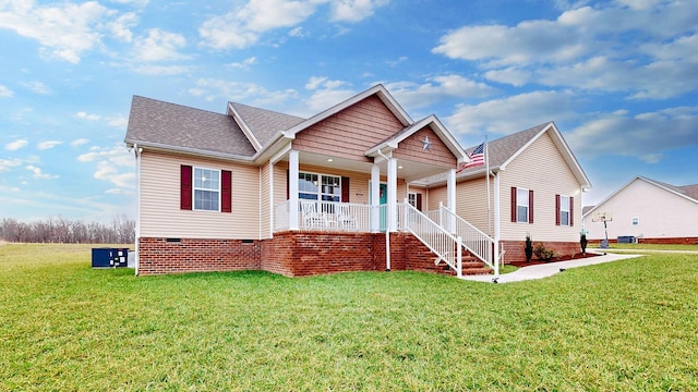 view of front facade with a porch, a front yard, crawl space, and a shingled roof