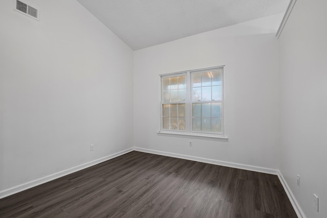 spare room featuring dark wood-type flooring