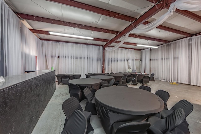 dining space featuring unfinished concrete flooring
