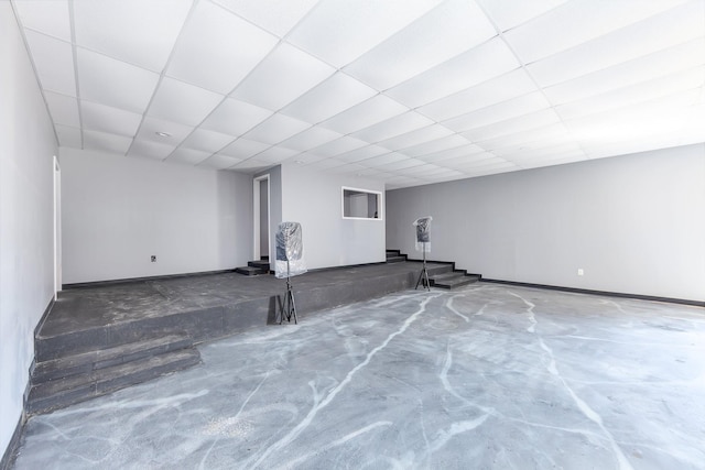 finished basement featuring a paneled ceiling