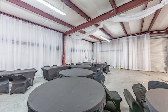 misc room with metal wall, concrete floors, and a garage