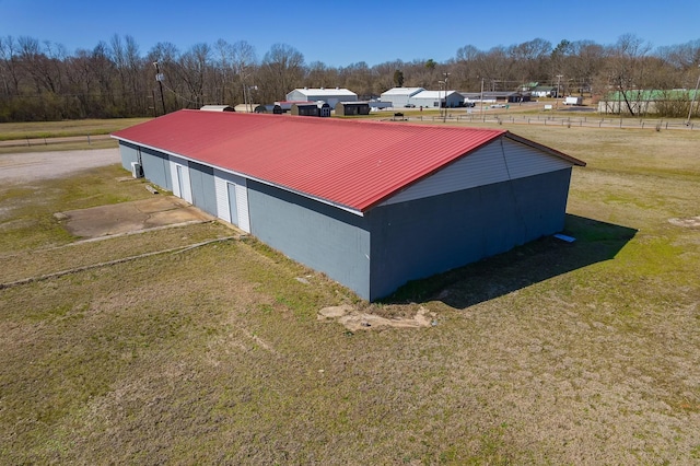 view of home's exterior featuring an outbuilding, a yard, an outdoor structure, and metal roof