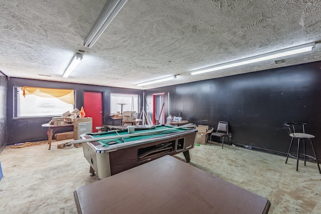 recreation room with a textured ceiling and pool table