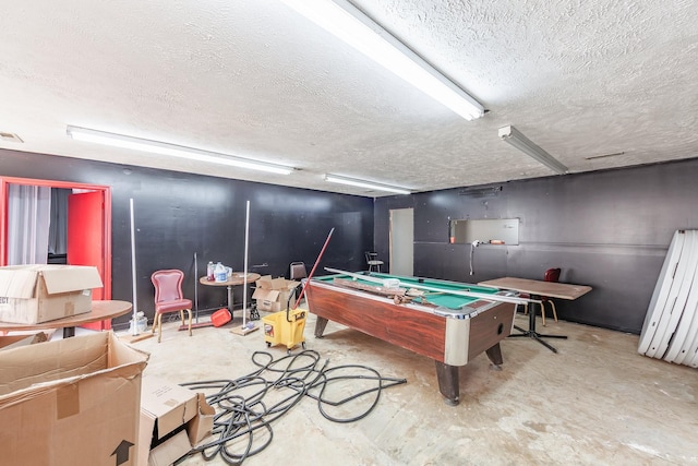 rec room with visible vents, unfinished concrete flooring, a textured ceiling, and billiards