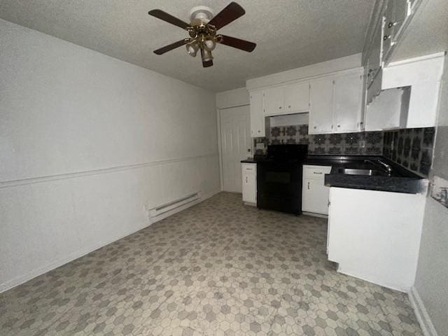 kitchen with stove, a baseboard heating unit, sink, and white cabinets