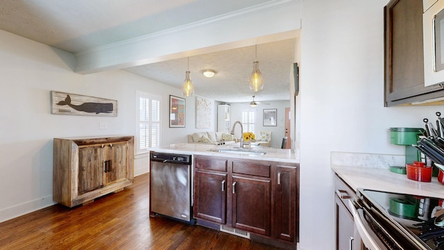 kitchen with a sink, light countertops, stainless steel dishwasher, hanging light fixtures, and dark wood-style floors