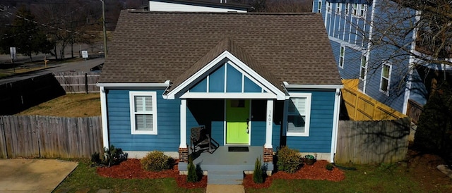 view of front of property with roof with shingles and fence private yard