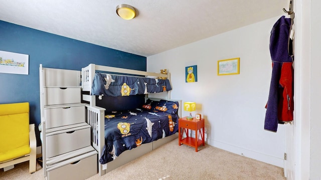 bedroom with baseboards and light colored carpet