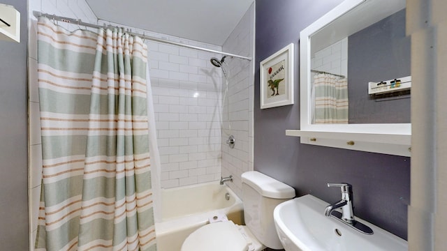 full bathroom with a sink, shower / bathtub combination with curtain, and toilet