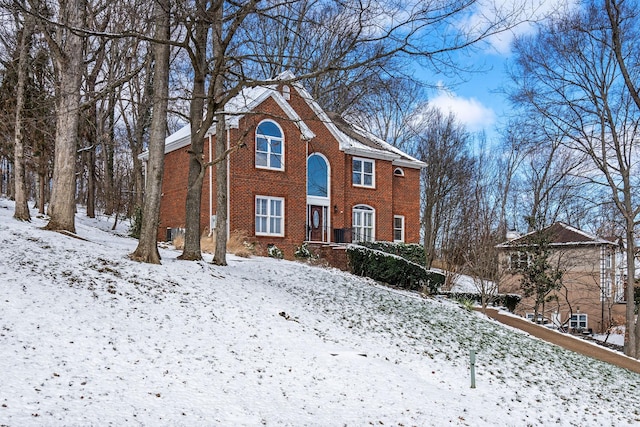 colonial house featuring brick siding